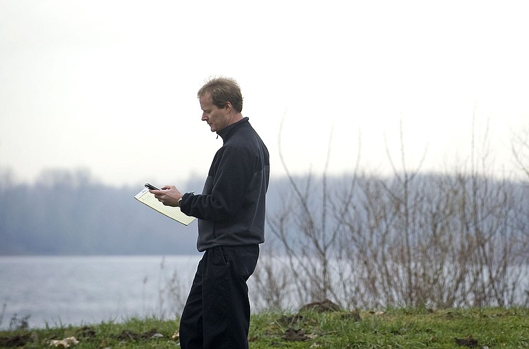 Port of Camas-Washougal communications manager Jack Hardy writes down latitude and longitude coordinates of a geocache he hid at a Washougal park in early December.