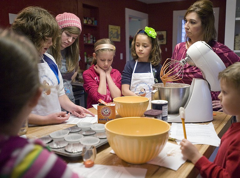 Heidi O'Connor, right, helps students make red velvet cupcakes at The Kids Cooking Corner.