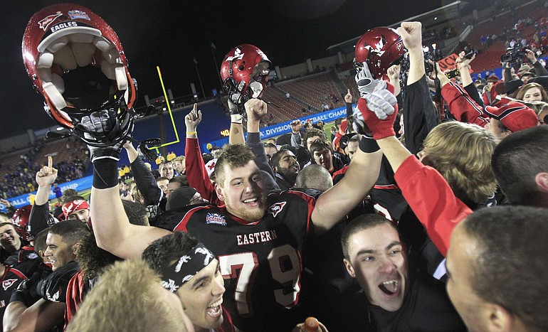 Eastern Washington offensive linesman Brice Leahy (79) celebrates with fans who ran onto the field after beating Delaware 20-19.