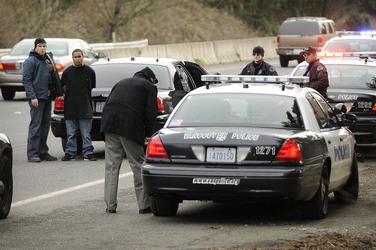 Police transport a bank robbery suspect after a chase in the eastbound lanes of state Highway 14 Tuesday January 11, 2011.