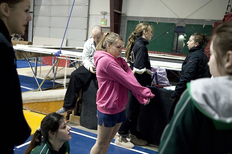 Jessica Heron stretches out a yawn while waiting for other team mates to start gymnastics practice Tuesday morning.  The Evergreen High School gymnastics team meets  at 5:15 am, 4 days a week, for practice at Vancouver Elite Gymnastics Academy.