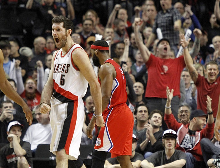 Portland Trail Blazers guard Rudy Fernandez, left, from Spain, reacts to scoring late in the game as Los Angeles Clippers guard Baron Davis walks to the bench at his right during the second half of their NBA basketball game in Portland, Ore., Thursday, Jan. 20, 2011.  Fernandez scored 17 points as the Blazers beat the Clippers 108-93.