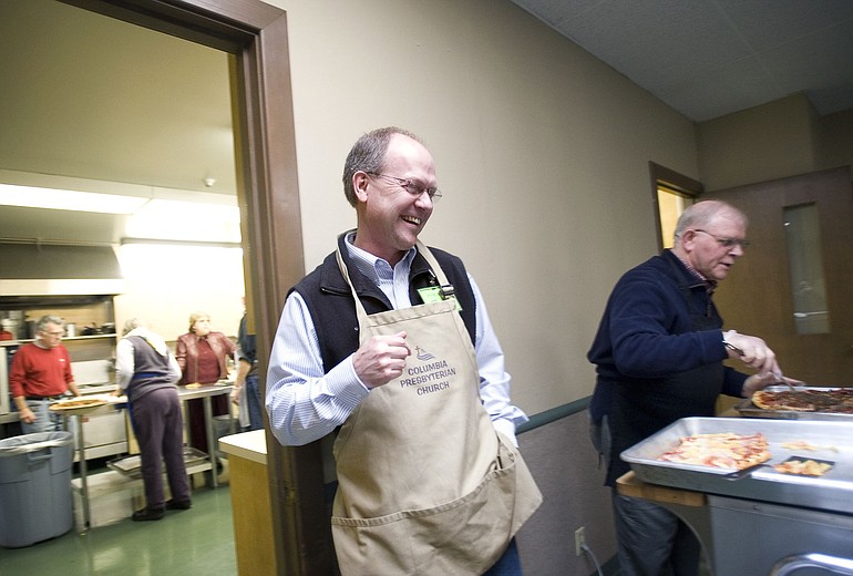 Bruce Cook, a divorce who now leads a recovery group at Vancouver's Columbia Presbyterian Church, helps serve a meal on a recent evening before the group meeting. Cook is among a growing number of Clark County residents divorcing, a trend that experts are grappling to understand.