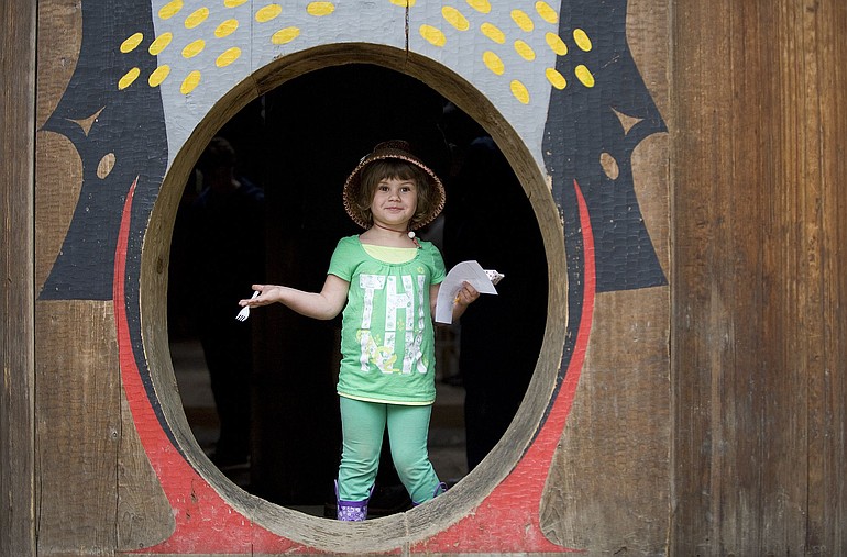 Destiny Reeves, 5, welcomes visitors to the Cathlapotle Plankhouse at the BirdFest and Bluegrass Festival in Ridgefield.