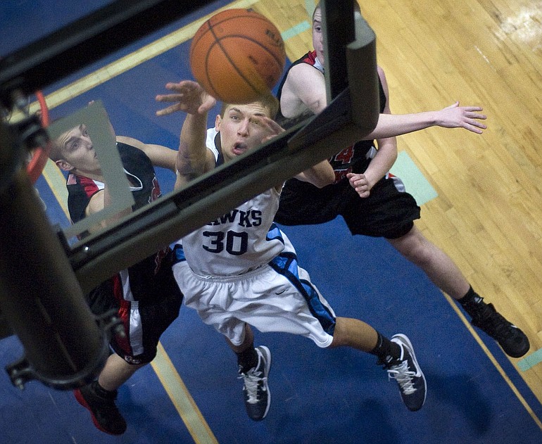 Hockinson's Joshua Hall battles puts up two points past R.A. Long defenders (from left) Sullivan Carter and Tyler VonDracek.