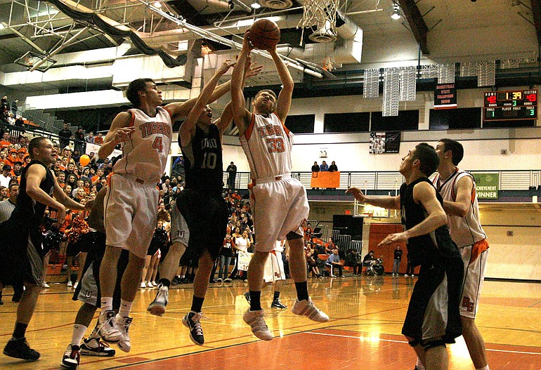 Battle Ground forward Seth Belknap (33) pulls down a rebound against Union during the Titans' Class 4A playoff victory on Friday night.