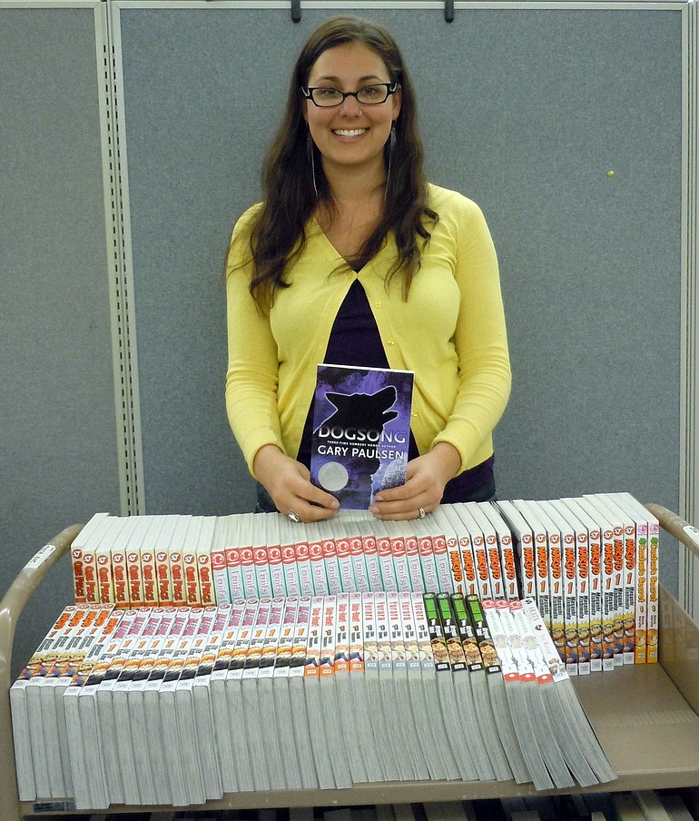 Jen Studebaker, young adult services coordinator at the Vancouver Barnes &amp; Noble, sorts through books donated by the community to the Fort Vancouver Library Foundation.