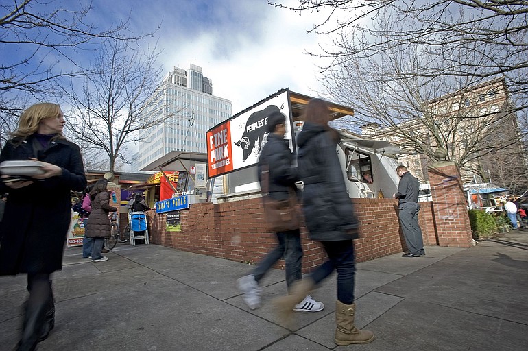 Despite a light drizzle and wind, the food carts at Southwest Alder Street and Southwest Ninth Avenue bustle with patrons during the lunch hour in downtown Portland this month.