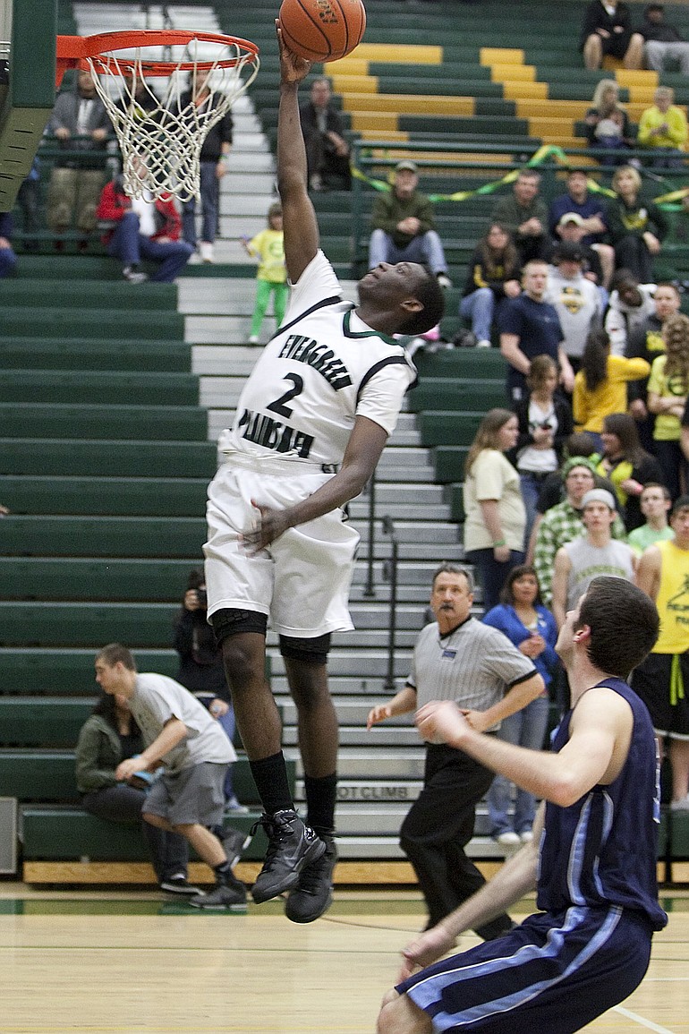 Warren Edmondson of Evergreen High takes the ball to the hoop during the Class 4A bi-district playoff game Thursday at Evergreen.