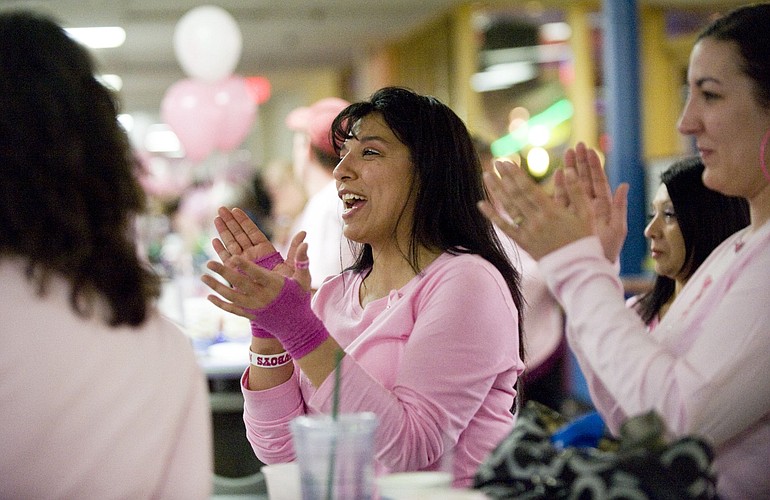 Breast cancer survivor Michelle Gonzalez of Battle Ground cheers on her team during a Bowl for the Cure event at Crosley Lanes on Sunday.