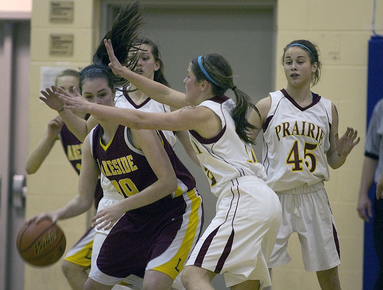Prairie defenders Cori Woodward, center, and Jackie Lanz (45) swarm Lakeside's Grace Noah during the first half Friday.