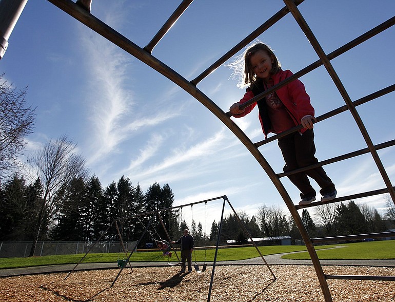 Madelyn Holmes, 6, climbs on the play structure at Holley Park in La Center on a recent sunny afternoon.