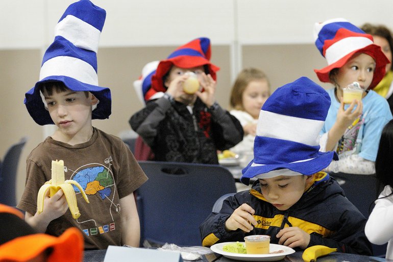 Cullen Cascadden, 7, left, and Van Higgs, 7, first-grade students at Benjamin Franklin Elementary School in Vancouver, enjoy a breakfast of Green Eggs and Ham. The colorful meal and hats pay tribute to children's author Dr.