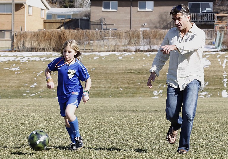 Elizabeth Marston, 10, left, practices soccer with her father, Bradley, at a school in Bountiful, Utah.