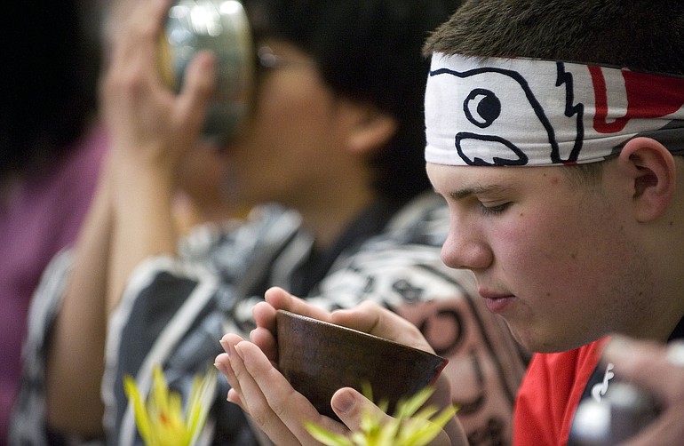 Cameron Holmes, 16, of Camas, sips a traditional bitter green tea during a Japanese tea service Saturday at the 6th Annual Japanese Festival at Washougal High School.