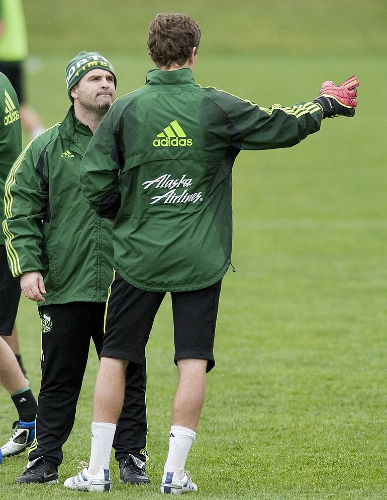 Portland Timbers coach John Spencer, left, talks to goalkeeper Troy Perkins as the team prepares for its opener.