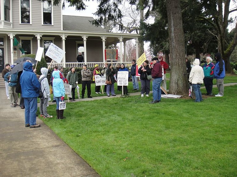 MoveOn.org supporters and counter-protesters rally Thursday outside the office of U.S. Rep. Jaime Herrera Beutler, R-Camas, at the O.O. Howard House.