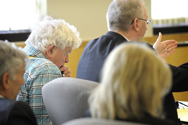 Richard Morse, 72, in plaid shirt, listens to his attorney, Jim Senescu, right, ask a witness questions during the opening day of his guardianship trial in Clark County Superior Court Judge Diane Woolard's courtroom on Monday.