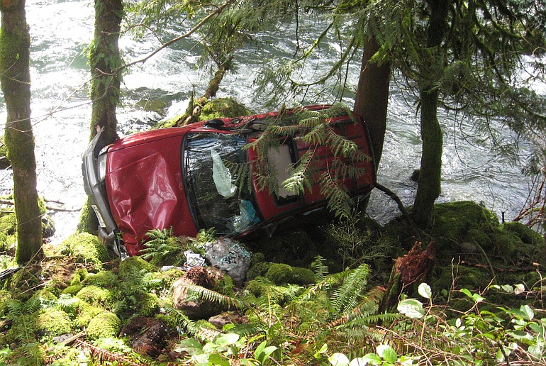 Fortunately placed trees kept this SUV from sliding off Northeast Lucia Falls Road into the East Fork of the Lewis River after a collision Saturday.