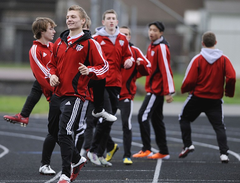 Camus's Drew White, front left, warms up with his team prior to a high school boys soccer game against Prairie in Battle Ground, Wa, Wednesday March 23, 2011.