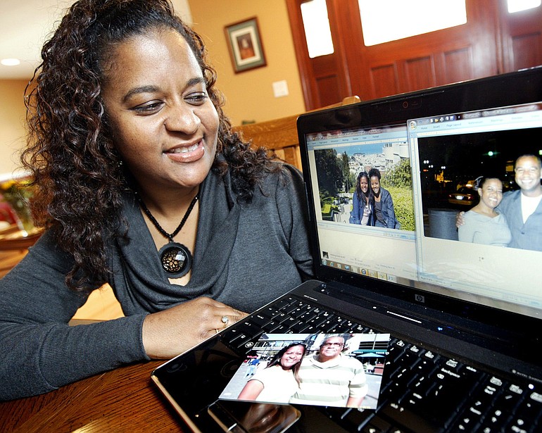 Shelley Hamilton of Fremont, Calif., shows the photos of her biological father, Mose Harris, her half-sister, Sharon Pendleton and her half-brother, Kevin Harris, whom she recently met for the first time.