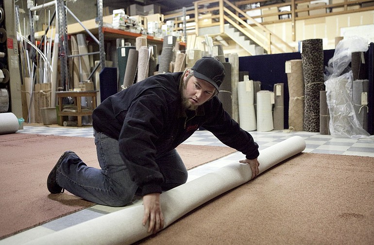 Alec Christensen fills orders for carpet in the warehouse at Michael's Floor Covering in Vancouver.