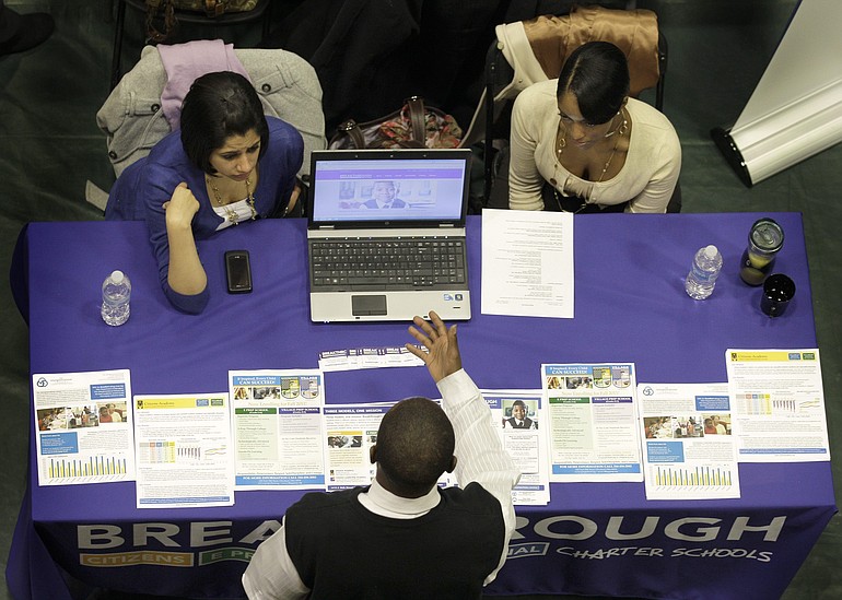 Representatives from Breakthrough Charter Schools, top, talk with a job seeker at the 32nd Annual Spring Career Fair at Cleveland State University.