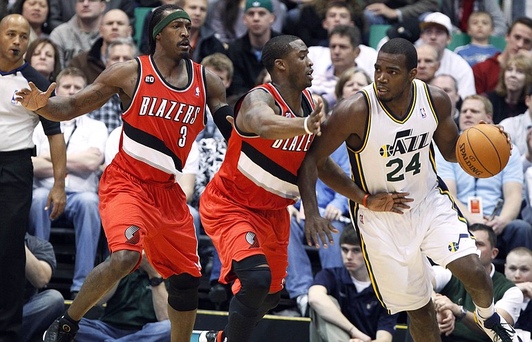 Utah Jazz forward Paul Millsap (24) is double-teamed by Portland Trail Blazers forward Gerald Wallace (3) and guard Wesley Matthews, center, and during the first half of an NBA basketball game Thursday, April 7, 2011, in Salt Lake City.