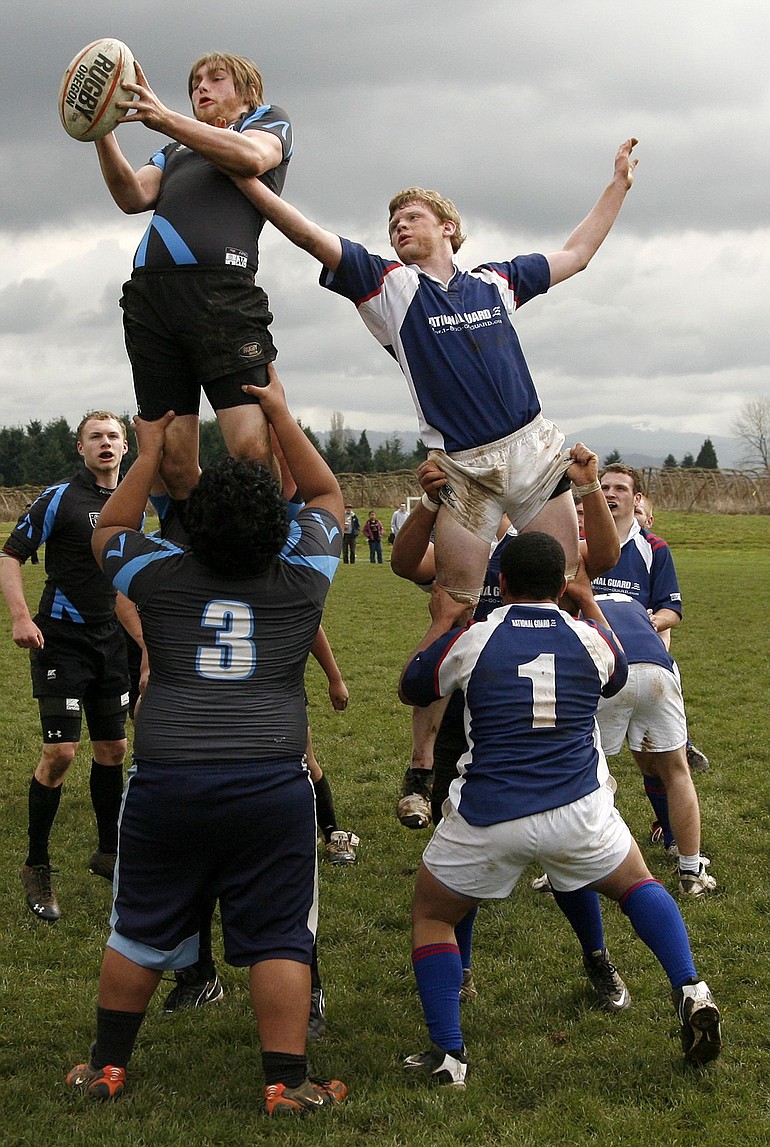 Prairie's Logan Fallon (right) reaches for the ball caught by Vancouver's Anton Weiman in line-out.