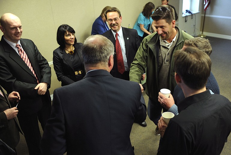 Camas Mayor Paul Dennis, in green jacket, introduces himself to a group of Polish visitors April 11 at the Camas Public Library.