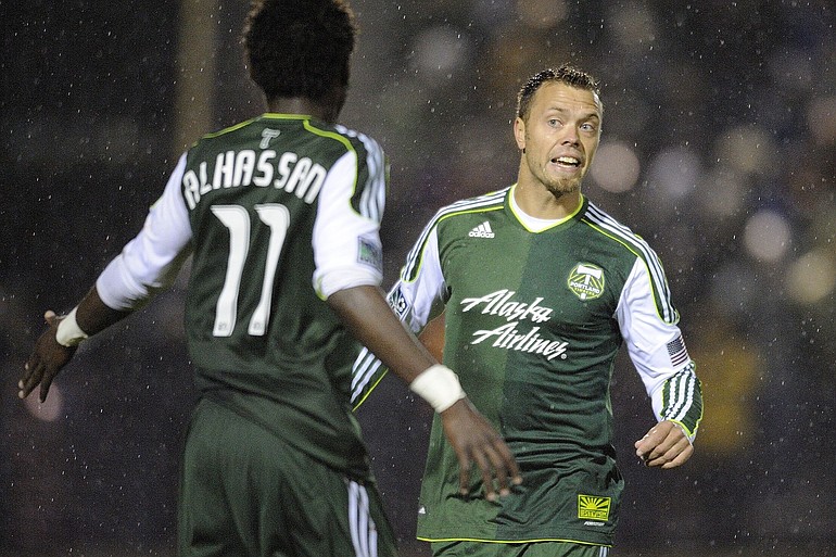Jack Jewsbury of the Portland Timbers relieves teammate Kalif Alhassan, 11, during a game against Chivas USA at Merlo Field.
