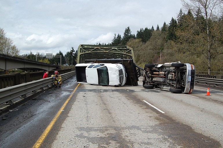 Fire Captain/Paramedic, Blaine Dohman checks the driver of the rolled over truck on northbound Interstate 5 near the bridge over the East Fork of the Lewis River.
