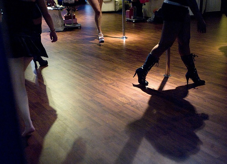 Women participate in a pole dancing fitness class at Linda Lee's Lingerie Boutique in downtown Vancouver.