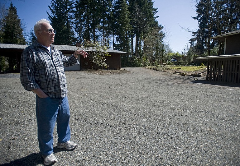Darrel Santesson stands in his newly acquired property across the street from where he and his wife, Norma, have lived for the past 36 years.