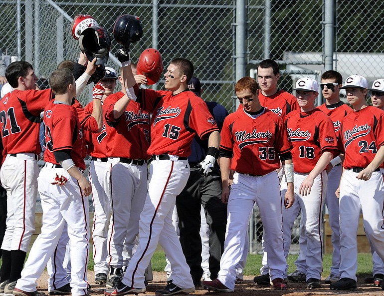 Teammates congratulate Austin Barr (15) on his three-run homer in the bottom of the first inning Tuesday for No.