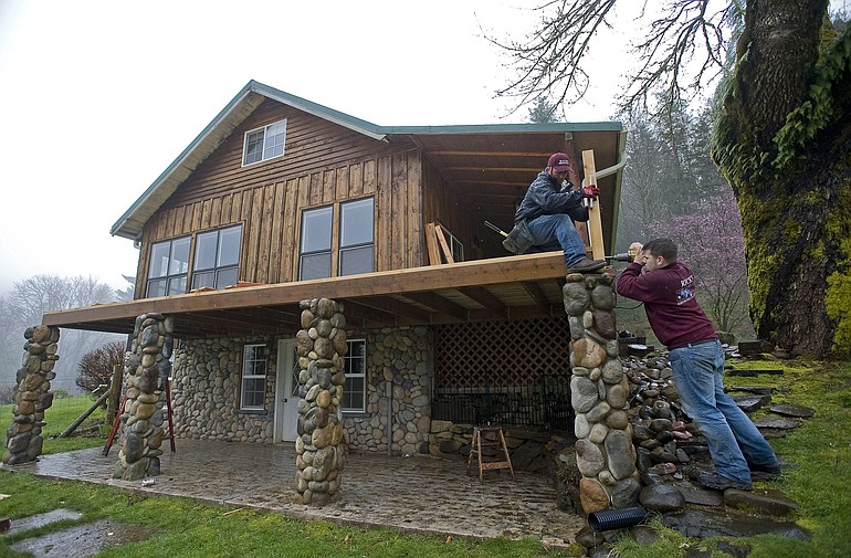 Rick's Custom Fencing &amp; Decking's Justin Skelton, left, and Jeremy McCoy, build a deck on a home near Yacolt.