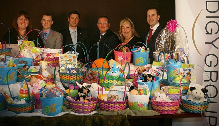 Sue Warren, from left, Chris Roberts, Vancouver Mayor Tim Leavitt, Brandon Dawson, Susie Oberst and Mason Walker stand behind Easter baskets donated to Share House.