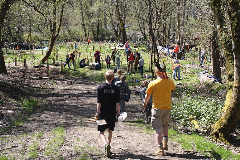 Hundreds of people turned out Saturday at Salmon Creek Regional Park to plant trees as part of StreamTeam's Earth Day celebration.