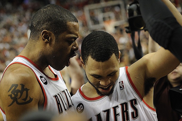 Brandon Roy, right, celebrates alongside Marcus Camby as they walk off the court after Game 4.