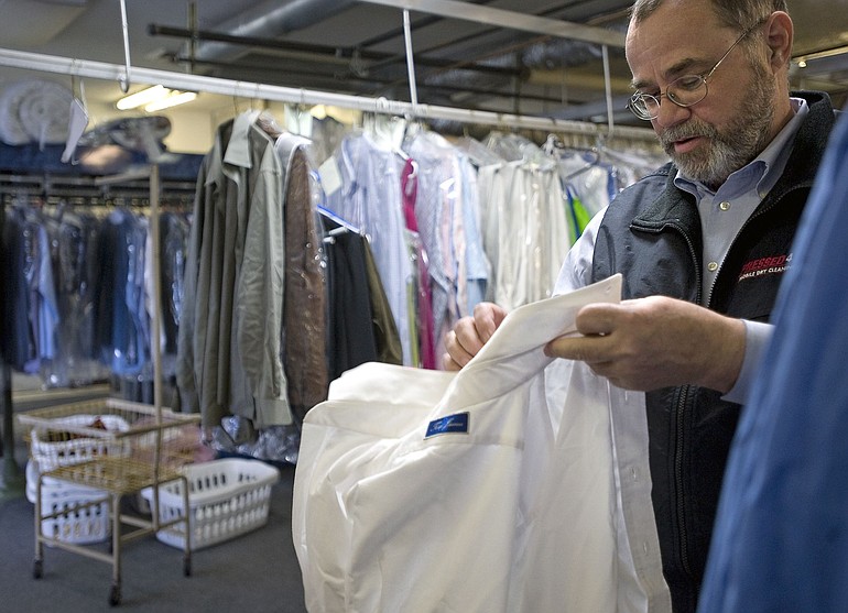 Clark County Cleaners owner Mark Nulph sorts clothing.