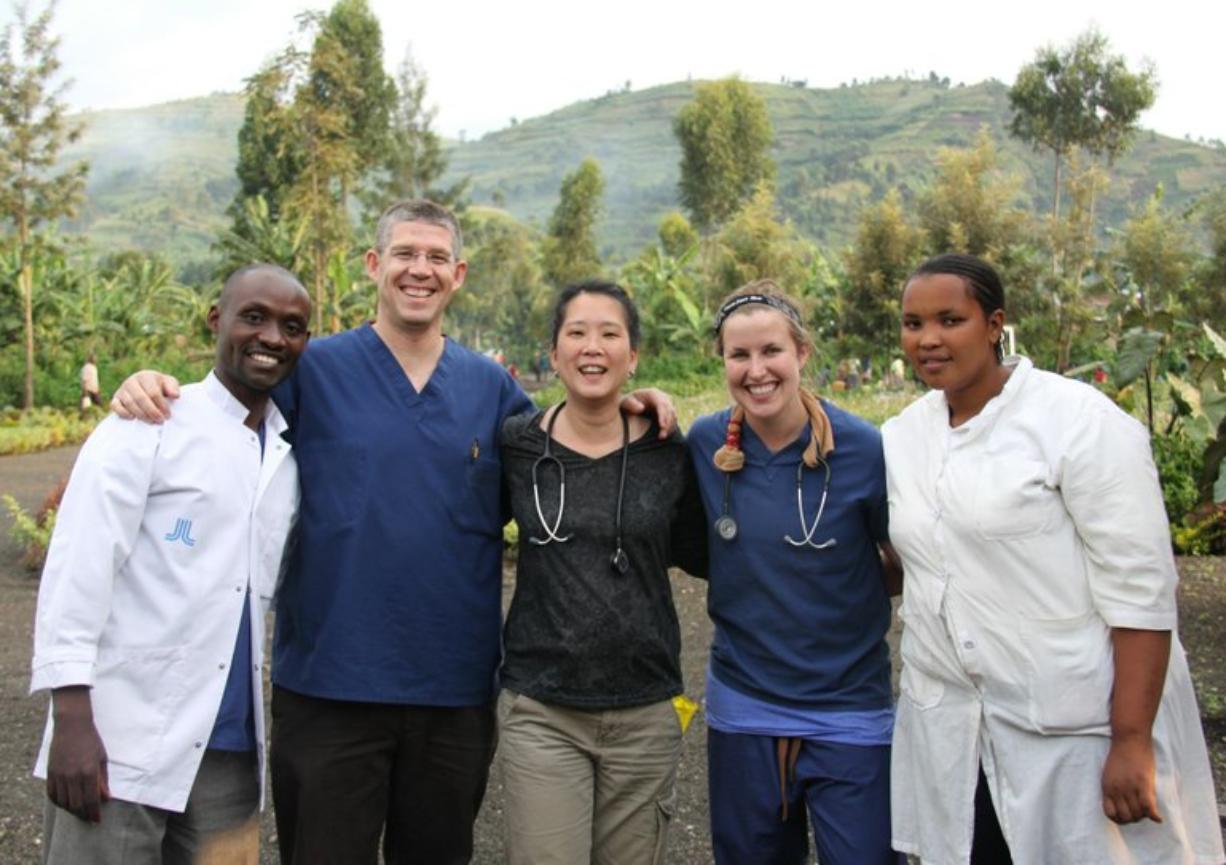 Dr. R. Scott Rushing, second from left, physician assistant Caroline Fung, center, and Southwest Washington Medical Center nurse Lindsey Lawry, second from right, pose for a picture with a doctor and nurse in Gisenyi, Rwanda.