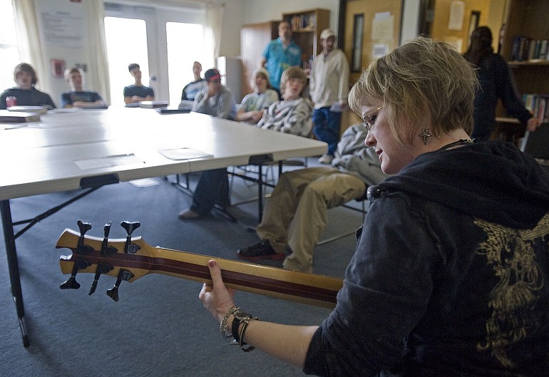 Lisa Mann, a local blues singer, plays original music for teen boys at the Daybreak drug rehab facility.
