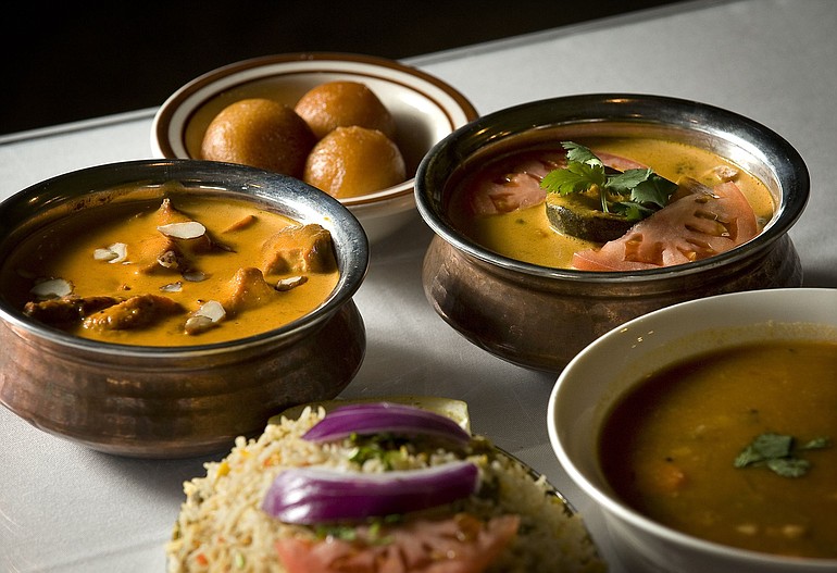 Clockwise from far left: Abhiruchi's Chicken Manchuria, Gulab Jamun (a dessert), Navaratan Koorma (mixed vegetables cooked with yogurt nuts), Sambar (lentil soup) and rice.