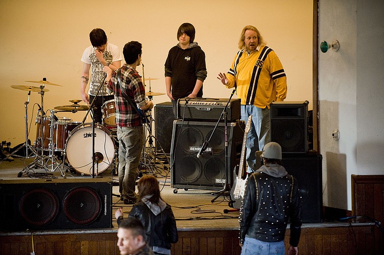 Michael Lind, upper right, helps local musicians set up for a show April 30 at The White Elephant in Hockinson.