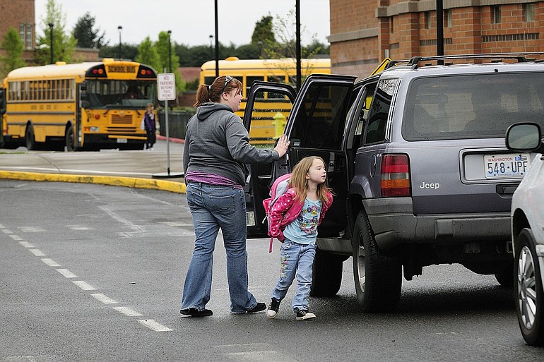 Shelley Cole drops her daughter, Bailey Cole, 6, off at Felida Elementary School. While many Clark County families choose to deliver their own children, school buses continue to carry nearly half the pupils in local schools, and statewide.