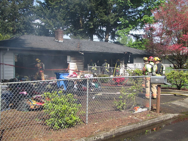 Clothes and other items belonging to a family whose home caught fire Friday were removed from the structure by firefighters and spread out on the driveway.