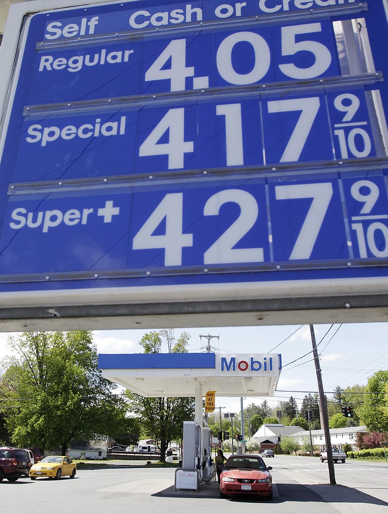 In this May 11 photo, gas prices are seen on a sign at a station in Mechanicville, N.Y. With gas prices hovering at $4 a gallon nationally, many Americans are making tough choices: scaling back summer vacations, driving less or ditching the car altogether.