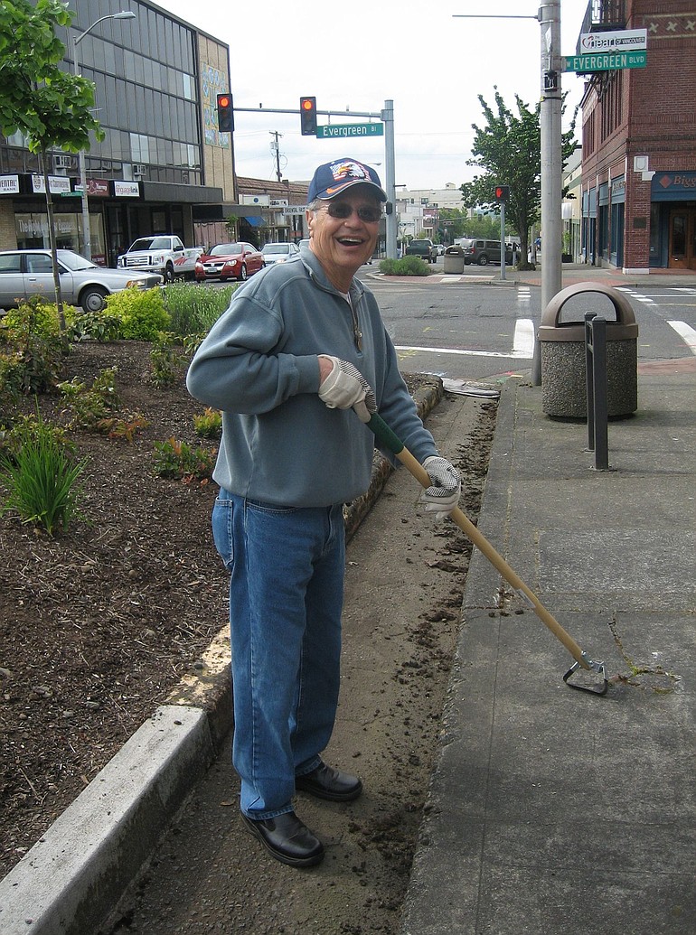 Volunteer Mike Calderon cleans Main Street.
