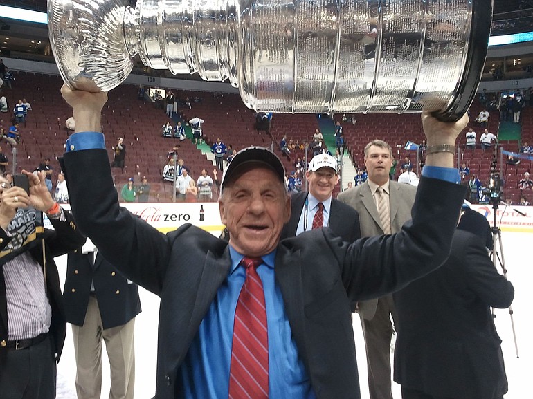 Vancouver resident Tom McVie raises Lord Stanley's Cup.