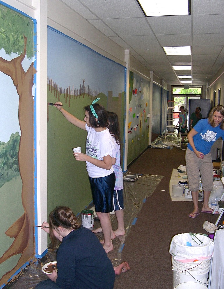 Esther Short: Members of the Mormon church Young Women Group work on a mural at the Children's Justice Center.